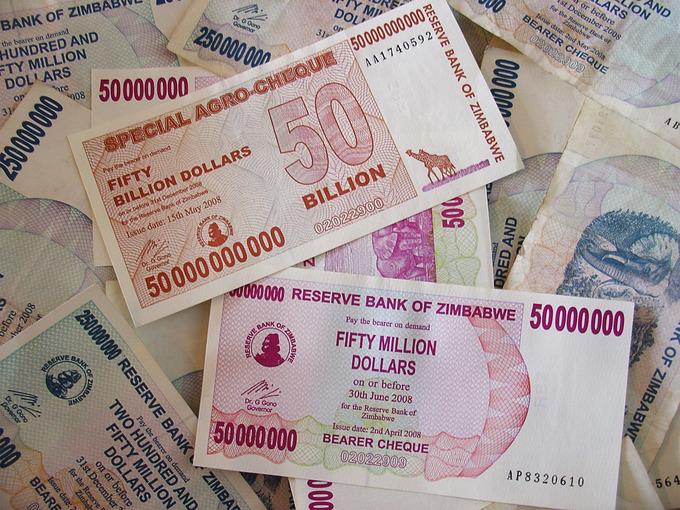 Causes of hyperinflation? Excess government spending? Causes of hyperinflation: Picture shows some 50 billion dollar Zimbabwean bank notes