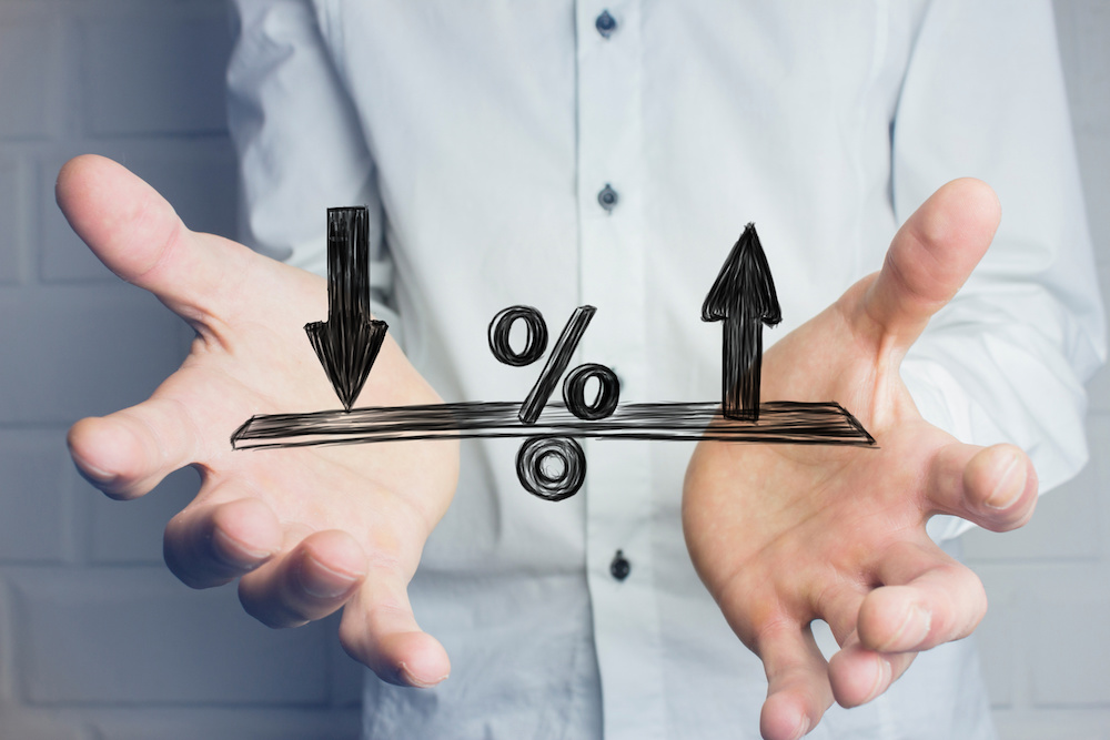 Angrynomics – The summary: Part 12 Angrynomics: Image of an interest rate "teeter totter" in front of the image of a person's torso