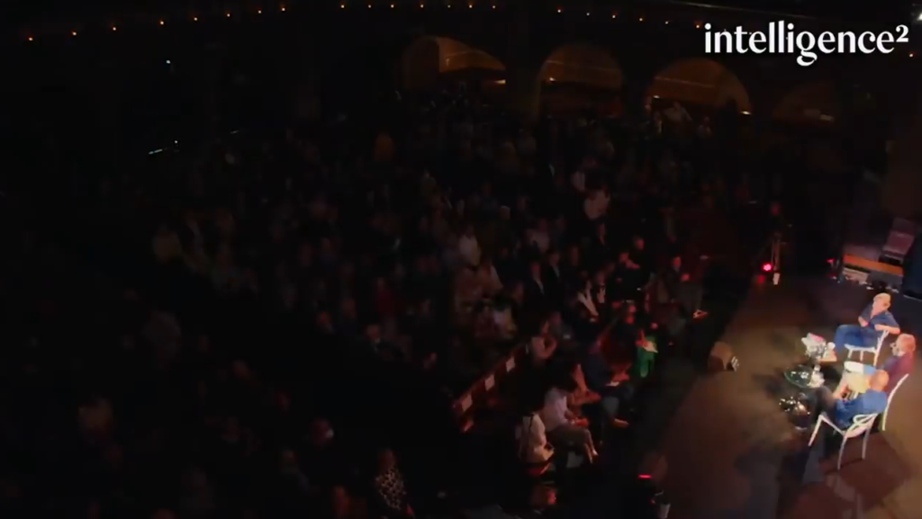 Saving capitalism: Image of the auditorium, showing Gillian Tett, Ann McElvoy, and Yanis Varoufakis on stage in the lower right and the audience in the auditorium.