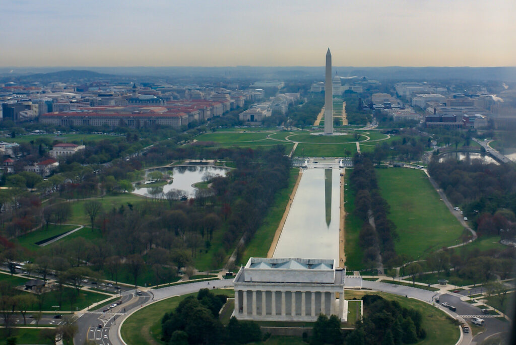 Institutionalism: What is it? Where did it come from? Institutionalism: The image is an aerial view of the Washington monument and the reflecting pond, showing the back of the Lincoln memorial in the foreground