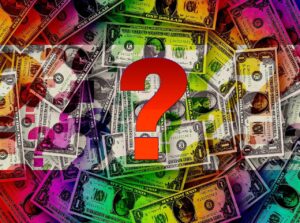 The existence of money: Image shows a set of scattered US currency notes with a large question mark in the foreground.