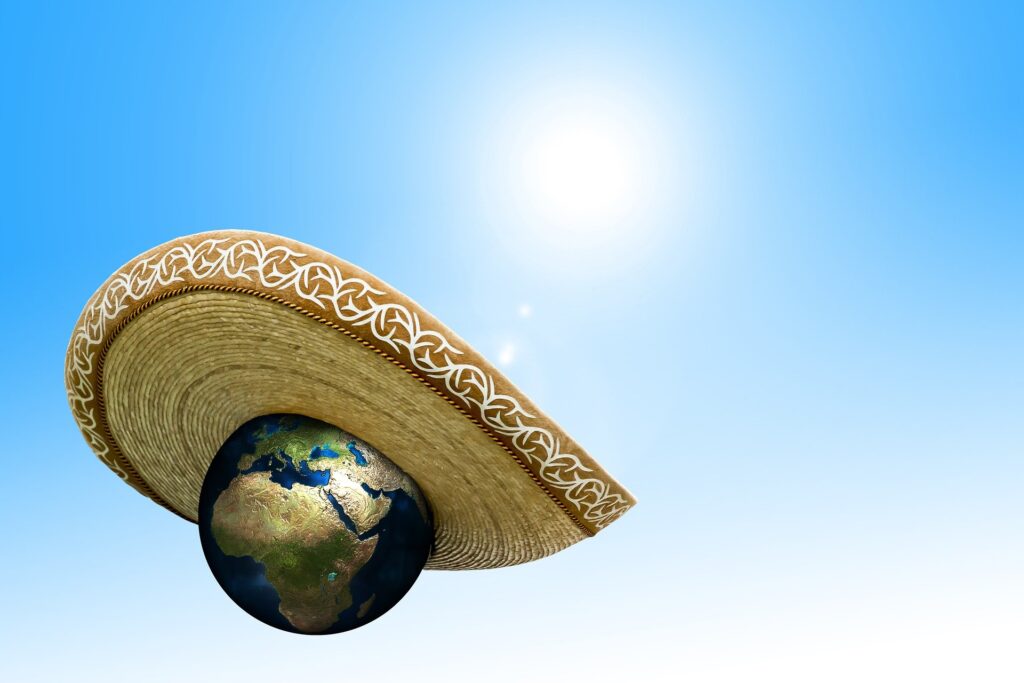 The Green New Deal: Yes we need it, but why? The Green New Deal: Image shows the earth wearing a sombrero to protect itself from the heat of the sun